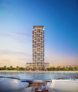 modern waterfront residential tower with balconies and greenery
