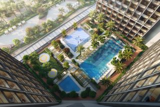 aerial view of swimming pools basketball court and landscaped garden