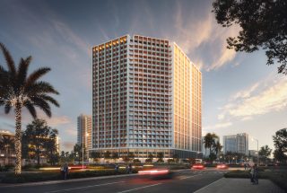 modern high rise residential building at sunset with palm trees