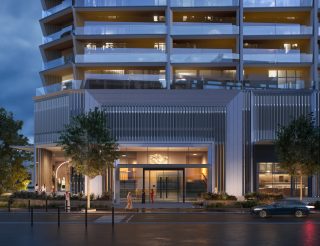 modern residential building entrance with illuminated facade at dusk