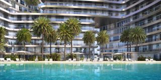 residential building with pool lounge chairs palm trees