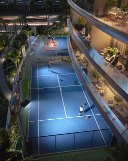 tennis courts with players near residential balconies
