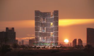 binghatti hills tower with sunset sky and illuminated terraces