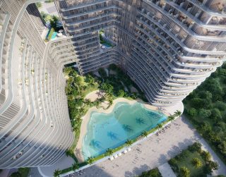 aerial view of binghatti hillviews tower with pool and gardens