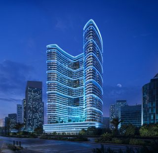 modern high rise building illuminated with blue neon lights at night