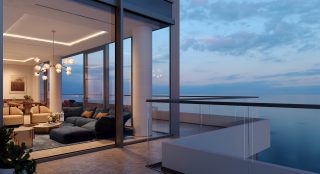 luxury penthouse balcony overlooking calm sea at sunset