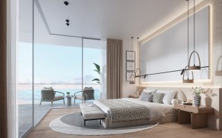 luxury bedroom with oceanfront glass wall