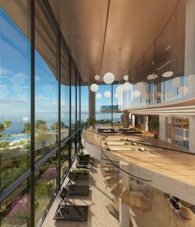 indoor amenity space with glass wall overlooking water and skyline