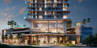 modern high rise building with illuminated entrance and balconies