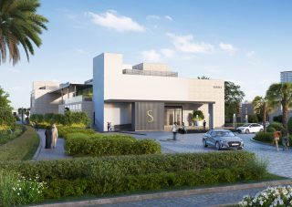modern clubhouse with large glass windows surrounded by greenery