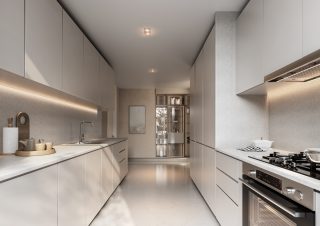 bright modern kitchen with light cabinetry and countertops