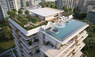 aerial view of rooftop pool with loungers and palm trees